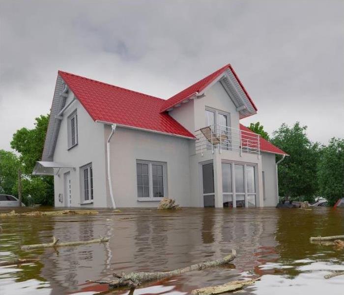 A house standing in flooded water.