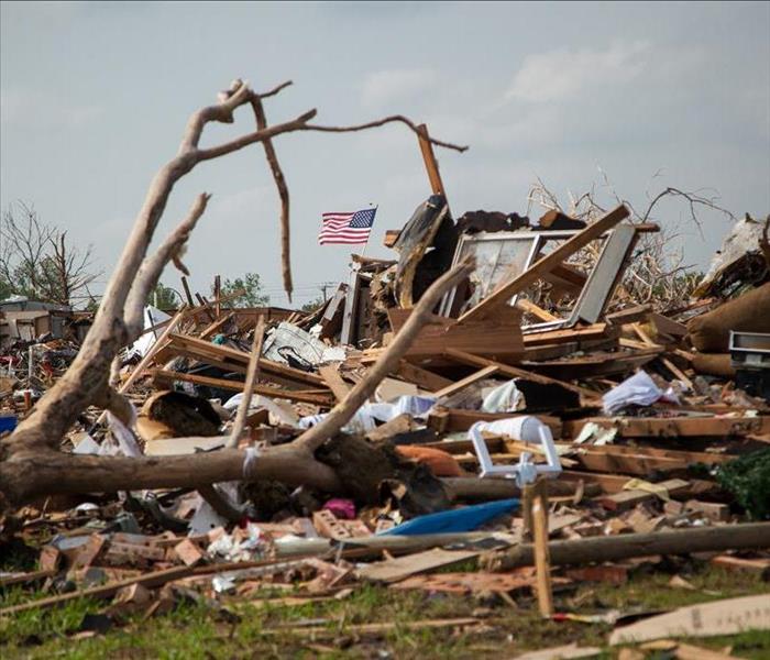 A tree fallen onto what once was a house. 